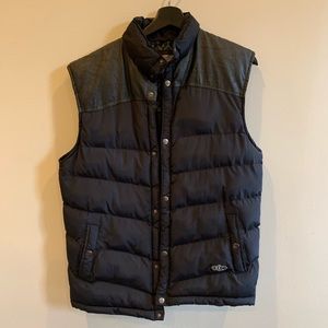 Black puffer vest with faux leather detail